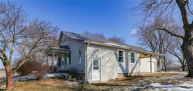 view of side of home with metal roof