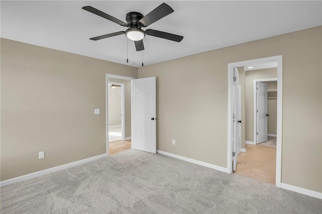 unfurnished bedroom featuring ceiling fan, carpet, and baseboards