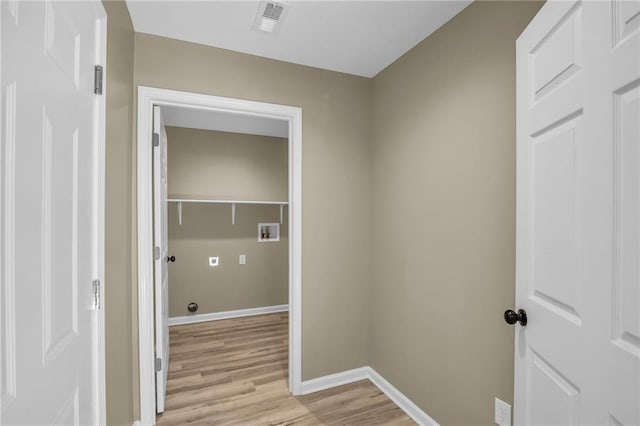 laundry room with hookup for a washing machine, visible vents, light wood-style flooring, laundry area, and baseboards