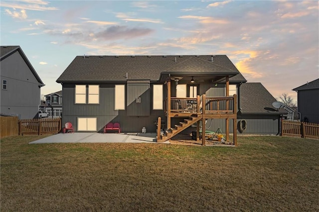 rear view of property with a fenced backyard, a lawn, stairs, and a patio