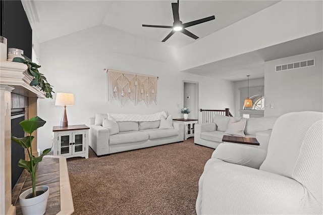 living area with a ceiling fan, carpet, visible vents, a premium fireplace, and lofted ceiling