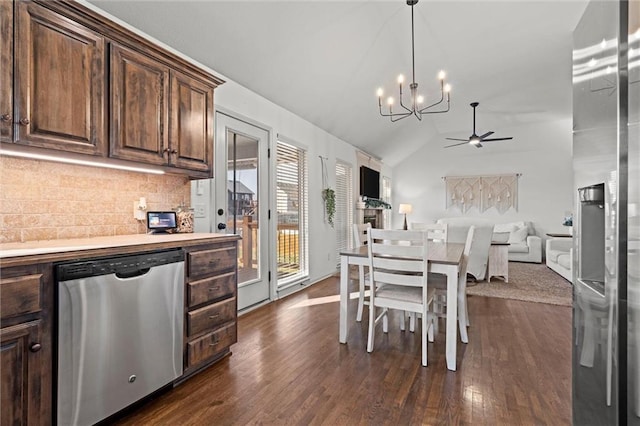 kitchen featuring stainless steel dishwasher, lofted ceiling, dark wood finished floors, and decorative backsplash