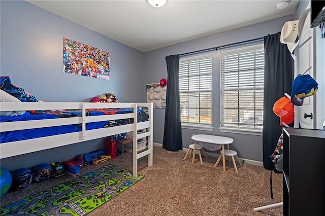 bedroom with baseboards and carpet