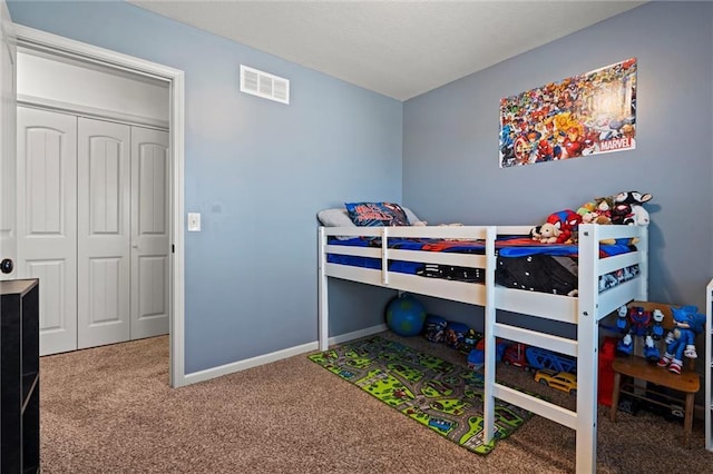 bedroom featuring a closet, baseboards, visible vents, and carpet floors