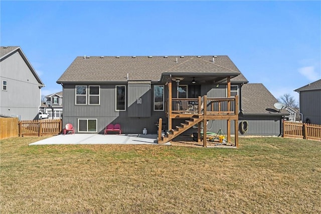 back of house featuring a yard, a patio, a fenced backyard, and stairs