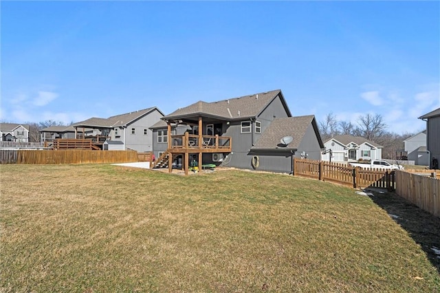 rear view of house featuring a residential view, a lawn, and a fenced backyard