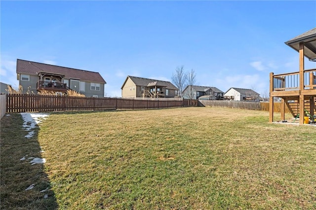 view of yard with a fenced backyard and a residential view