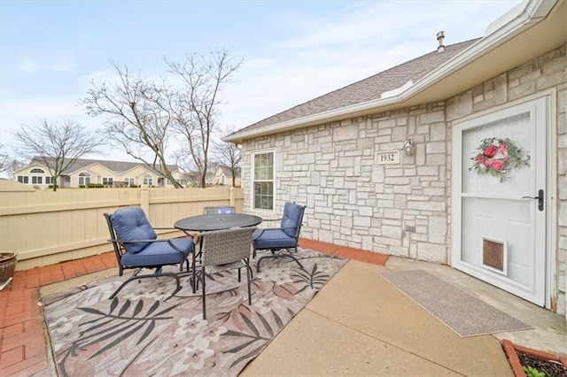 view of patio / terrace with outdoor dining space and fence