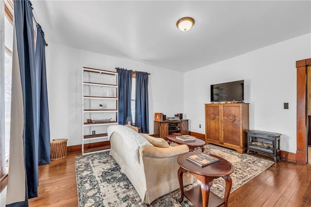 living area featuring wood finished floors and baseboards