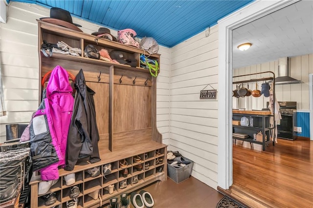 mudroom featuring wood walls