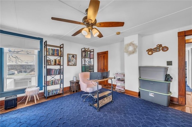 interior space with cooling unit, baseboards, and ceiling fan