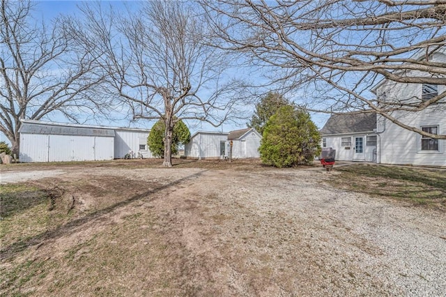 view of yard with an outbuilding and a pole building