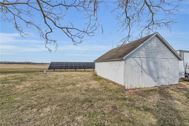 view of outbuilding with solar panels and an outdoor structure