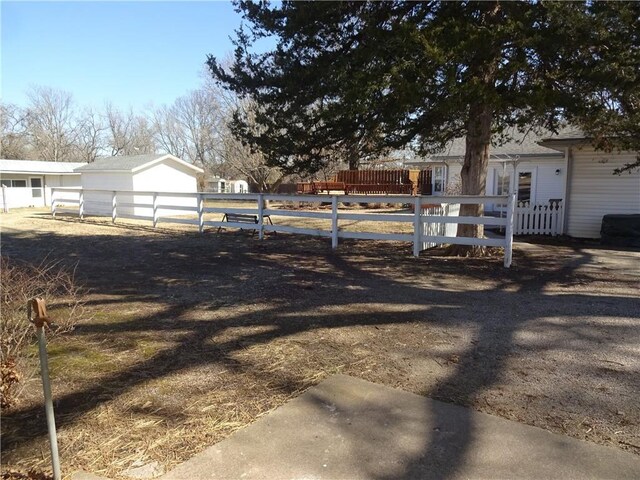 view of yard with an outdoor structure and fence