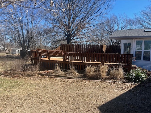 view of yard with a wooden deck and fence