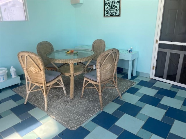 dining area with baseboards and tile patterned floors