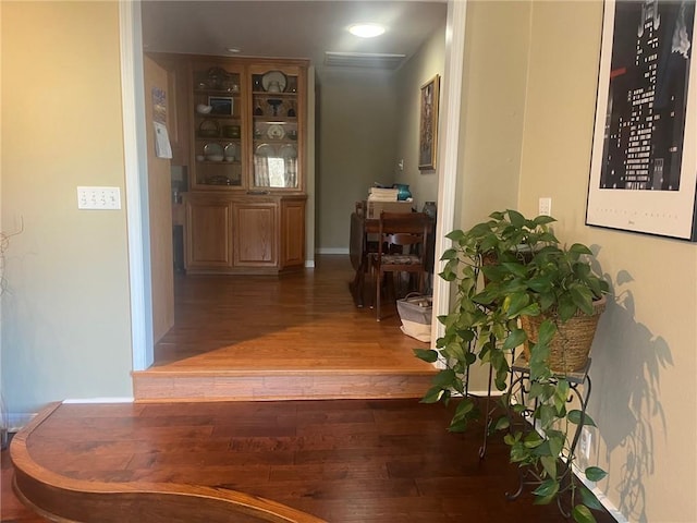 hall with wood finished floors and baseboards