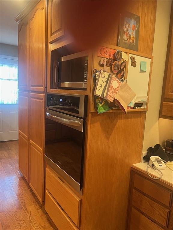 kitchen with light wood-style floors and appliances with stainless steel finishes