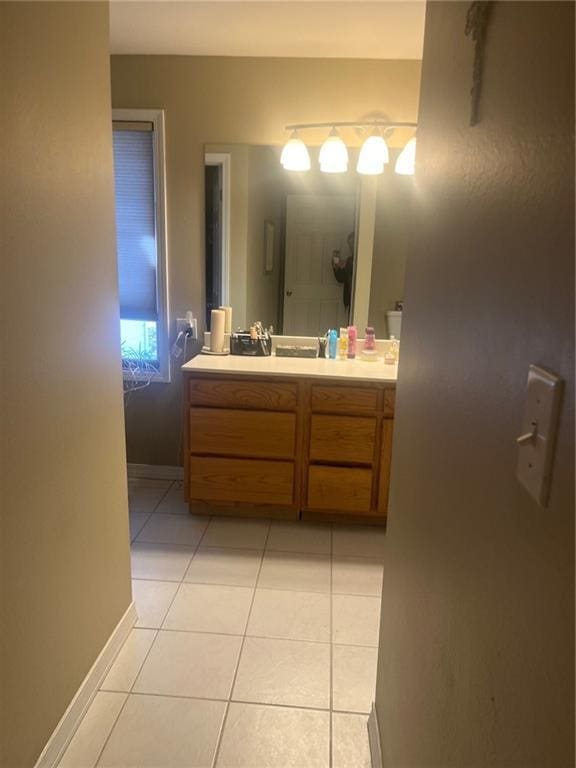 bathroom featuring baseboards, vanity, and tile patterned floors