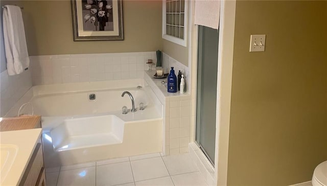 bathroom featuring a garden tub, toilet, tile patterned flooring, vanity, and a shower stall