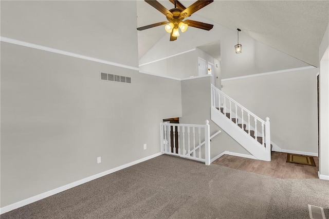 interior space with carpet, baseboards, visible vents, and ceiling fan