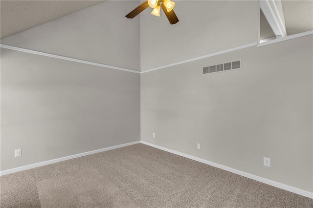 carpeted empty room featuring visible vents, baseboards, lofted ceiling, and a ceiling fan