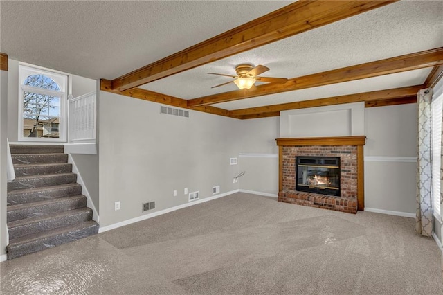 unfurnished living room with beam ceiling, baseboards, visible vents, and a textured ceiling