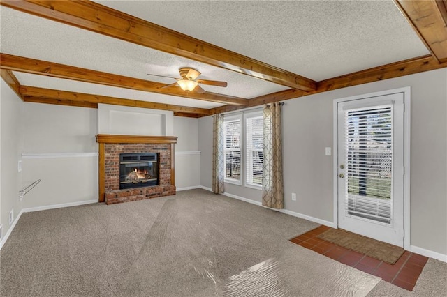 unfurnished living room with baseboards, carpet floors, beam ceiling, a textured ceiling, and a ceiling fan