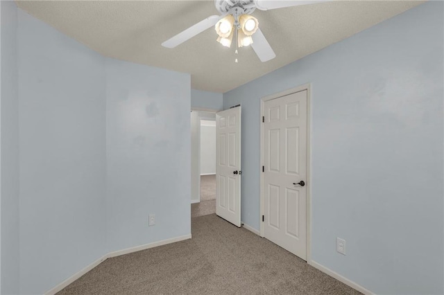 unfurnished bedroom with baseboards, carpet, and a ceiling fan