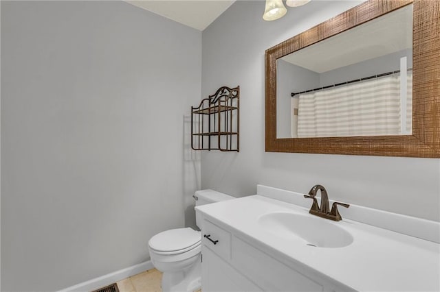 bathroom featuring vanity, a shower with curtain, baseboards, tile patterned flooring, and toilet