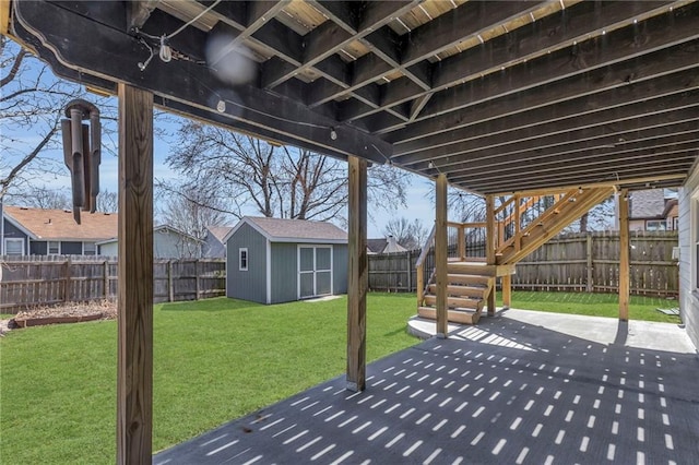 view of patio featuring a fenced backyard, a storage shed, and an outdoor structure