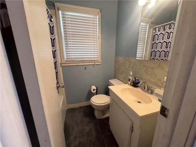 full bath featuring curtained shower, vanity, toilet, and tile patterned floors