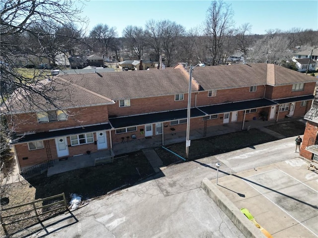 exterior space with brick siding and a residential view