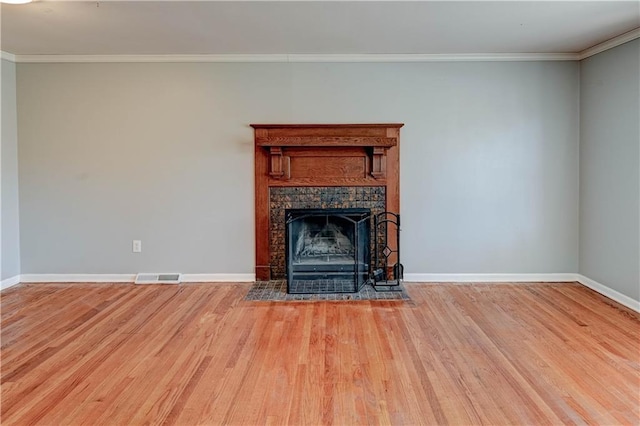 unfurnished living room featuring visible vents, crown molding, and wood finished floors