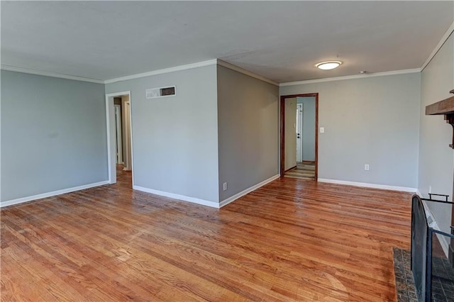 unfurnished living room with light wood finished floors, baseboards, visible vents, and crown molding