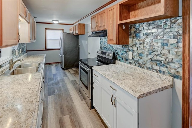 kitchen featuring a sink, wood finished floors, exhaust hood, appliances with stainless steel finishes, and backsplash