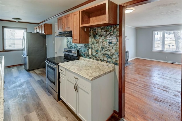 kitchen featuring ornamental molding, appliances with stainless steel finishes, visible vents, and under cabinet range hood