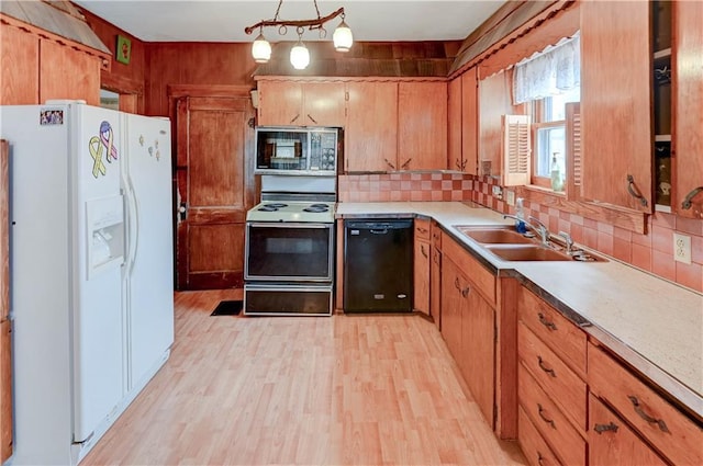 kitchen with range with electric stovetop, a sink, light wood-style floors, dishwasher, and white fridge with ice dispenser