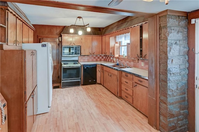 kitchen with range with electric cooktop, dishwasher, stainless steel microwave, freestanding refrigerator, and a sink