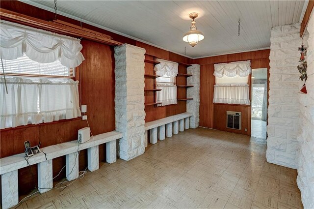 mudroom featuring wood walls, a wealth of natural light, and heating unit