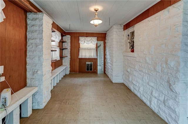 hallway featuring wood walls