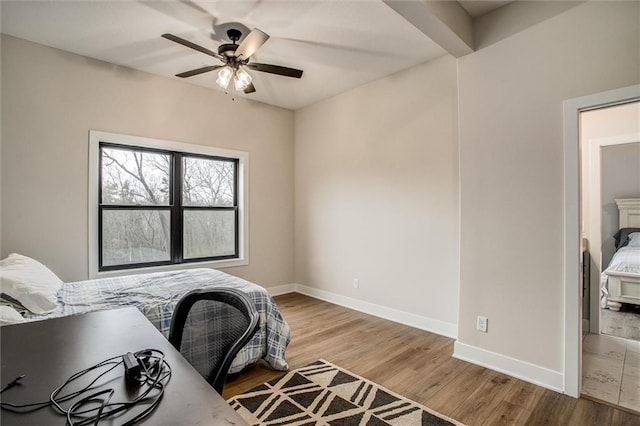 home office with baseboards, ceiling fan, and wood finished floors