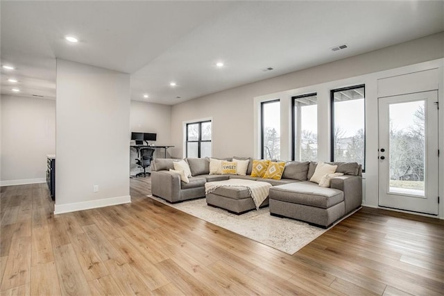 living room featuring recessed lighting, baseboards, visible vents, and wood finished floors
