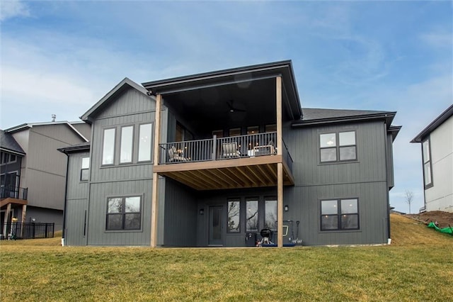 rear view of house featuring a yard and a balcony
