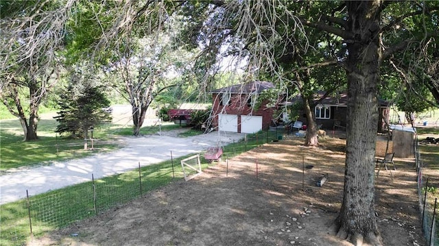 view of street with driveway and a gated entry