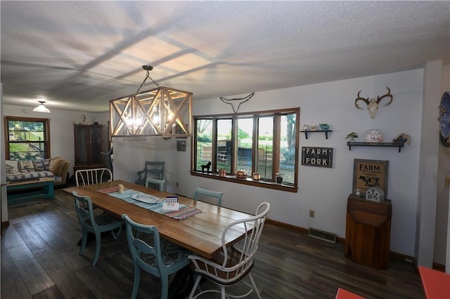 dining area with a textured ceiling, a wealth of natural light, dark wood-style floors, and visible vents