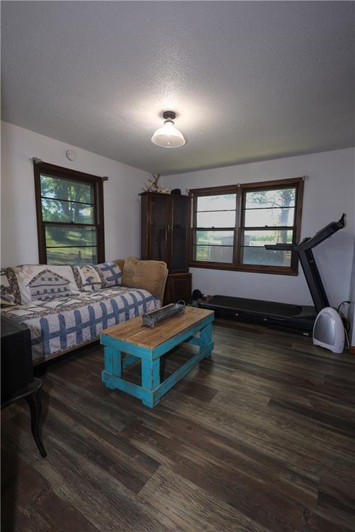 bedroom with a textured ceiling and wood finished floors