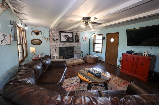 living area with ceiling fan, wood finished floors, and beam ceiling