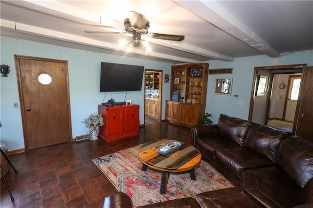 living area featuring a ceiling fan, beamed ceiling, and baseboards