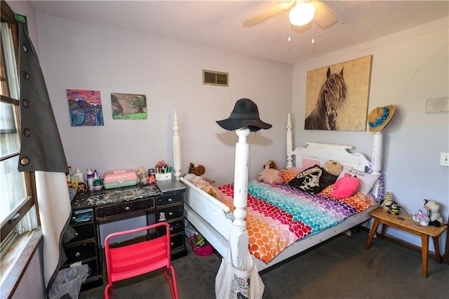 carpeted bedroom with a ceiling fan, visible vents, and a textured ceiling